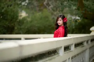 Graceful Vietnamese Beauty: Traditional Ao Dai Adorned with a Vibrant Red Flower-14