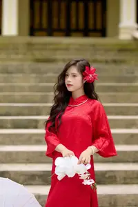 Graceful Vietnamese Beauty: Traditional Ao Dai Adorned with a Vibrant Red Flower-2
