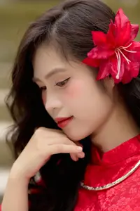 Graceful Vietnamese Beauty: Traditional Ao Dai Adorned with a Vibrant Red Flower-3
