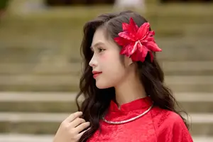 Graceful Vietnamese Beauty: Traditional Ao Dai Adorned with a Vibrant Red Flower-0