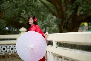 Graceful Vietnamese Beauty: Traditional Ao Dai Adorned with a Vibrant Red Flower-5