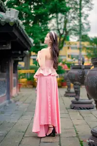 Graceful Woman in Pink Dress Amidst Ancient Heritage Charm 1000025280-5