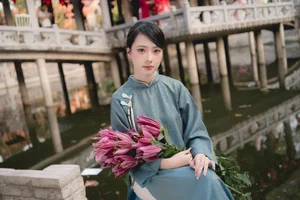 Classic Elegance: Vietnamese Tradition in Blue Silk and Pink Lilies-1