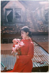Vintage Ao Dai Beauty: Elegant Vietnamese Woman with Flowers in a Nostalgic Setting-2