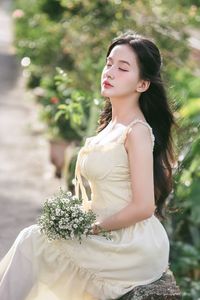Serene Natural Beauty: Gentle Girl in Cream Dress Amidst Lush Garden-7