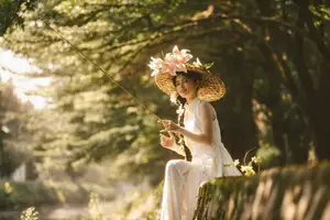 Serene Vietnamese Beauty in White Ao Dai with Lilies: A Golden Hour Portrait 1000025192-4