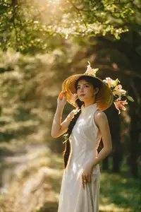 Serene Vietnamese Beauty in White Ao Dai with Lilies: A Golden Hour Portrait 1000025192-6