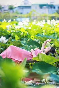 Elegant Vietnamese Girl in Pink Ao Yem by Lotus Pond, Capturing Traditional Beauty and Serenity-1