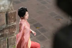 Graceful Asian Young Woman in Traditional Pink Attire: Timeless Beauty by an Ancient Wall-3