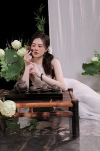 Elegant Vietnamese Girl in White, Embracing Tea Ceremony and Lotus Flowers – Traditional Beauty.-5