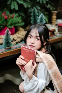 Cozy Christmas Reading: Young Woman and 'How to Win Friends' Book-0