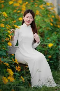 Radiant Youth: Vietnamese Girl in Elegant White Ao Dai Amidst Golden Blooms-13