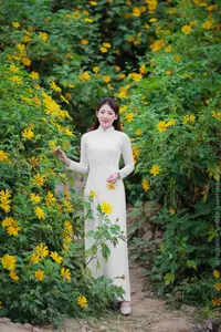 Radiant Youth: Vietnamese Girl in Elegant White Ao Dai Amidst Golden Blooms-22