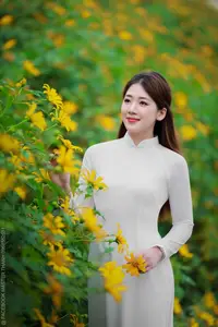 Radiant Youth: Vietnamese Girl in Elegant White Ao Dai Amidst Golden Blooms-5