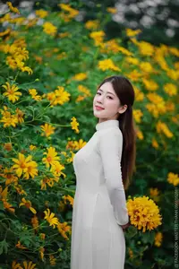 Radiant Youth: Vietnamese Girl in Elegant White Ao Dai Amidst Golden Blooms-12