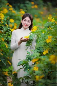 Radiant Youth: Vietnamese Girl in Elegant White Ao Dai Amidst Golden Blooms-10