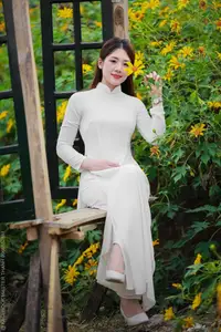 Radiant Youth: Vietnamese Girl in Elegant White Ao Dai Amidst Golden Blooms-21
