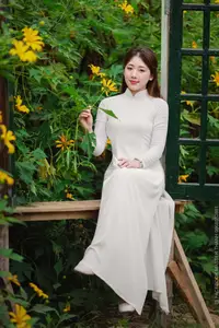 Radiant Youth: Vietnamese Girl in Elegant White Ao Dai Amidst Golden Blooms-9