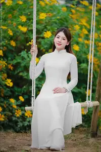 Radiant Youth: Vietnamese Girl in Elegant White Ao Dai Amidst Golden Blooms-15