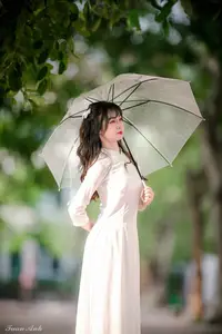 Graceful Vietnamese Girl in Elegant White Ao Dai with Sweet Finger Heart Gesture-4