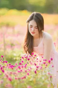 Serene Beauty: Young Woman in Pink Dress Amidst a Vibrant Flower Field-3