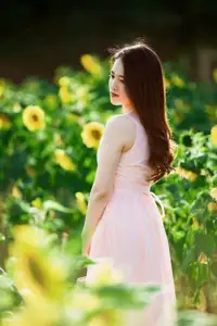 Serene Beauty: Young Woman in Pink Dress Amidst a Vibrant Flower Field-1
