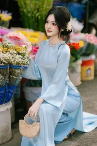 Traditional Vietnamese Beauty: Graceful Girl in Blue Ao Dai with Fresh Flowers-3