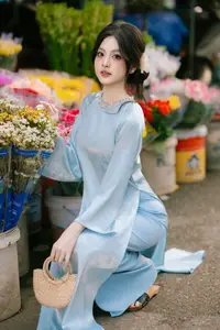 Traditional Vietnamese Beauty: Graceful Girl in Blue Ao Dai with Fresh Flowers-7