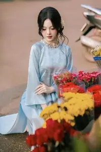 Traditional Vietnamese Beauty: Graceful Girl in Blue Ao Dai with Fresh Flowers-1