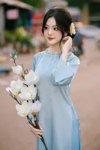 Traditional Vietnamese Beauty: Graceful Girl in Blue Ao Dai with Fresh Flowers-9