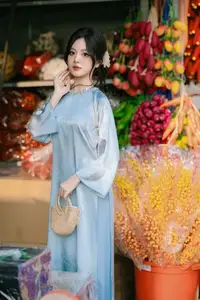 Traditional Vietnamese Beauty: Graceful Girl in Blue Ao Dai with Fresh Flowers-4