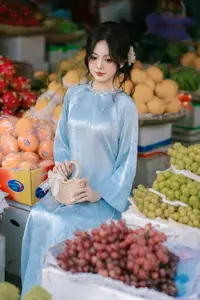 Traditional Vietnamese Beauty: Graceful Girl in Blue Ao Dai with Fresh Flowers-6