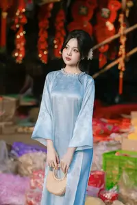 Traditional Vietnamese Beauty: Graceful Girl in Blue Ao Dai with Fresh Flowers-13