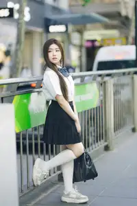 Charming Schoolgirl Embraces Street Style with Classic Uniform.-2