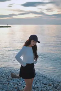 Dreamy Sunset by the Sea: Young Woman Relaxing and Gazing-3