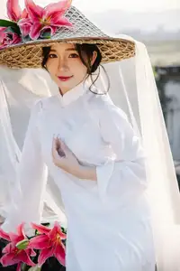 Discover the captivating grace of a Vietnamese woman in a flowing white Ao Dai and traditional conical hat-23