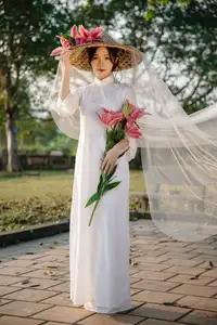 Discover the captivating grace of a Vietnamese woman in a flowing white Ao Dai and traditional conical hat-21