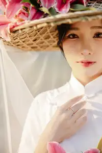 Discover the captivating grace of a Vietnamese woman in a flowing white Ao Dai and traditional conical hat-11