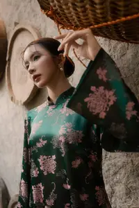 Elegant Asian Beauty: Serene Woman in Modernized Traditional Dress with Vintage Floral Vase-3