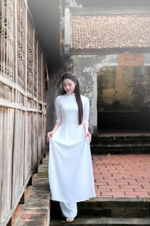 Elegant Vietnamese Woman in Traditional White Ao Dai, Gracing an Ancient Pathway | 1000017528-4