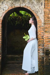 Elegant Vietnamese Woman in Traditional White Ao Dai, Gracing an Ancient Pathway | 1000017528-7