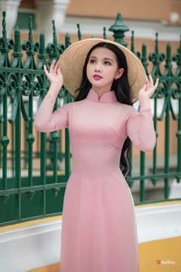 Graceful Vietnamese Woman in Pink Ao Dai: A Stunning Portrayal of Traditional Asian Beauty 1000019457-8