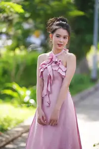 Gentle Charm: A Girl in an Elegant Pink Dress Amidst Nature's Embrace-4