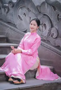 Discover the Graceful Beauty of a Vietnamese Girl in Traditional Pink Ao Dai 1000028168-0