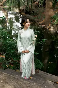 Graceful Vietnamese Woman in Light Green Ao Dai Amidst Tranquil Garden-4