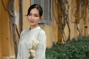Graceful Vietnamese Woman in Light Green Ao Dai Amidst Tranquil Garden-7