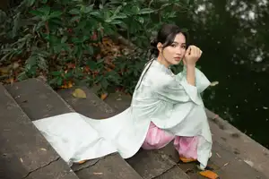 Graceful Vietnamese Woman in Light Green Ao Dai Amidst Tranquil Garden-9