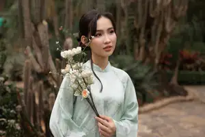 Graceful Vietnamese Woman in Light Green Ao Dai Amidst Tranquil Garden-0