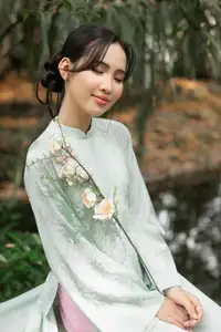 Graceful Vietnamese Woman in Light Green Ao Dai Amidst Tranquil Garden-5