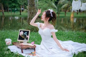 Serene Young Woman in White Dress Reading Book in Lush Nature-5
